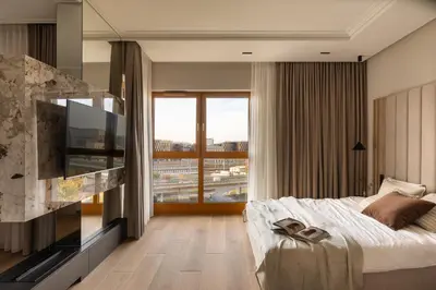 a bedroom with a large bed and a large window at Panoramic Landmark View City Center FREE Parking in Kraków