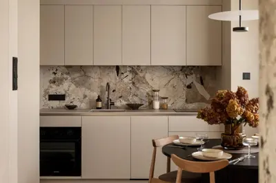 a kitchen with white cabinets and a table at Panoramic Landmark View City Center FREE Parking in Kraków