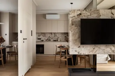 a kitchen and dining room with a tv on a wall at Panoramic Landmark View City Center FREE Parking in Kraków