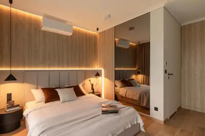 a hotel room with two beds and lights at Panorama suite City Center Main Station in Kraków