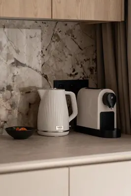 a counter with a coffee maker and a toaster at Panorama suite City Center Main Station in Kraków
