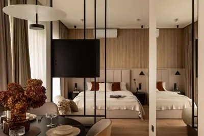a bedroom with a bed and a living room with a table at Panorama suite City Center Main Station in Kraków