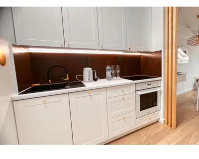 a kitchen with white cabinets and a sink at The perfect cozy Oasis in Kraków