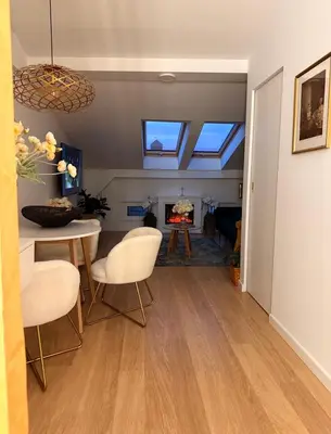 a living room with a table and chairs and a fireplace at The perfect cozy Oasis in Kraków