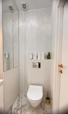 a white bathroom with a toilet and a shower at The perfect cozy Oasis in Kraków
