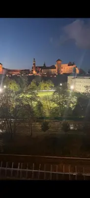 a view of a city at night with lights at The perfect cozy Oasis in Kraków