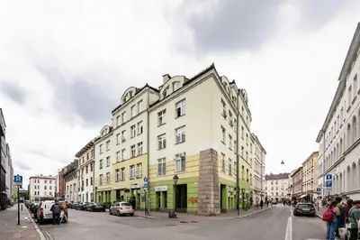 a yellow and white building on a city street at Apartment Warszauera 3 in Kraków