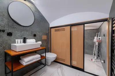a bathroom with a sink and a toilet and a mirror at Paulińska 30 Kraków Spacious Apartment Kazimierz in Kraków