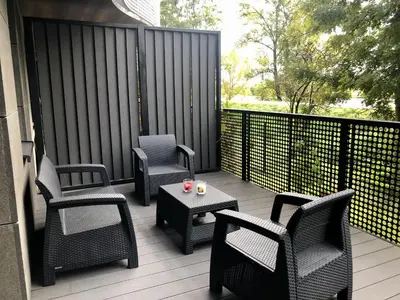 a patio with chairs and a table on a deck at Wiślane Pianissimo apartament in Kraków