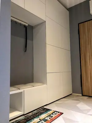 a room with a white cabinet and a rug on the floor at Wiślane Pianissimo apartament in Kraków