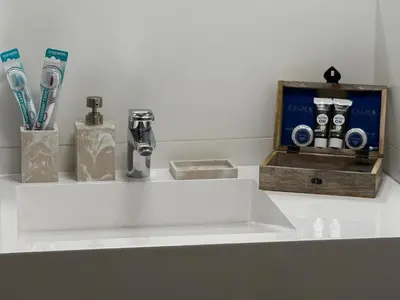 a bathroom sink with a faucet and toothbrushes at Wiślane Pianissimo apartament in Kraków