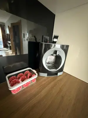 a microwave with a tray of strawberries in front of it at Wiślane Pianissimo apartament in Kraków