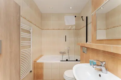 a bathroom with a tub and a sink and a toilet at Cracow Vistula Harmony Apartment by BookingHost in Kraków