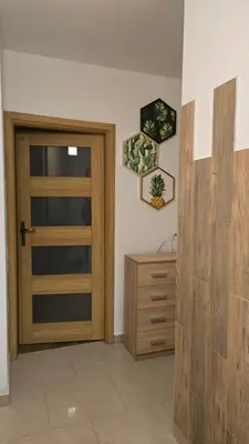 a television sitting on a cabinet in a room at Park & Arena Apartament Kraków in Kraków