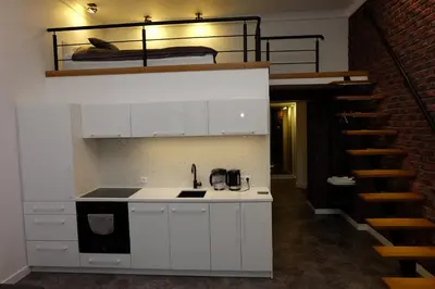 a kitchen with a sink and a bunk bed at Apartament Elementos in Kraków