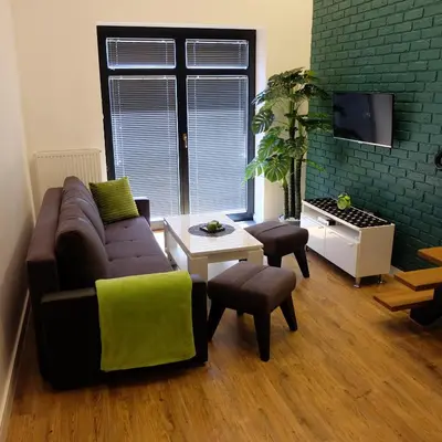 a living room with a couch and a table at Apartament Elementos in Kraków