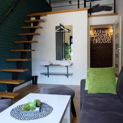 a living room with a couch and a table at Apartament Elementos in Kraków