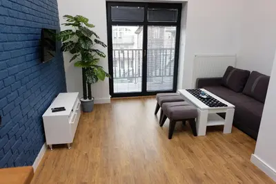 a living room with a couch and a table at Apartament Elementos in Kraków