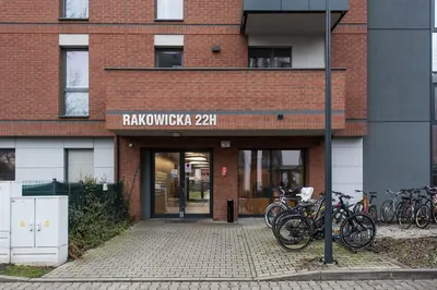 a brick building with bikes parked outside of it at Krakowiak Apartment 89 in Kraków