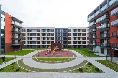 a park with a playground in front of a building at Krakowiak Apartment 89 in Kraków