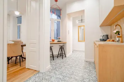 a bedroom with a large white bed and a table at Design Apartment Kazimierz, Old Town Area in Kraków