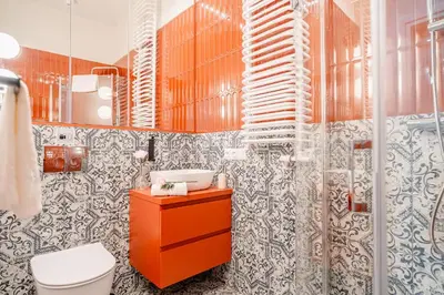 a bathroom with a toilet and a sink and a mirror at Design Apartment Kazimierz, Old Town Area in Kraków