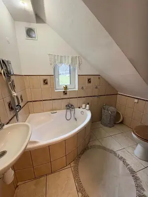 a bathroom with a tub and a sink at Dom w górach Zacisze lasu in Sucha Beskidzka