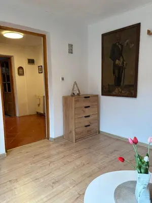 a room with a dresser and a painting on the wall at Dom w górach Zacisze lasu in Sucha Beskidzka