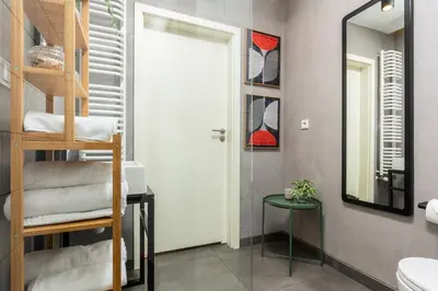 a bathroom with a ladder next to a mirror at Old Town Loft Designed with Love in Kraków