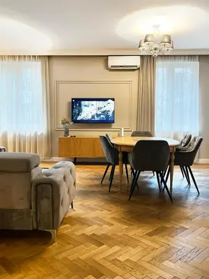 a dining room with a table and chairs and a tv at Premium Apartment for 6 guests city center with 2 bedrooms and living room in Kraków