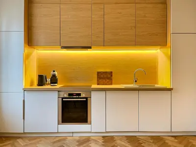 a kitchen with white cabinets and a sink at Premium Apartment for 6 guests city center with 2 bedrooms and living room in Kraków