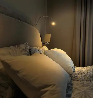 a bed with white sheets and pillows in a bedroom at Premium Apartment for 6 guests city center with 2 bedrooms and living room in Kraków