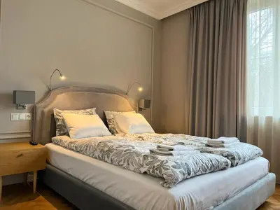 a bedroom with a large bed with a large window at Premium Apartment for 6 guests city center with 2 bedrooms and living room in Kraków