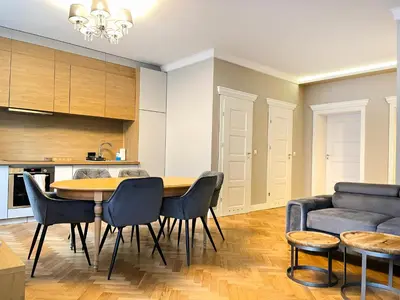 a kitchen and living room with a table and chairs at Premium Apartment for 6 guests city center with 2 bedrooms and living room in Kraków