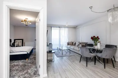 a living room with a bed and a dining room at Riva Cracovia in Kraków
