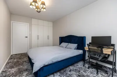 a bedroom with a bed and a desk with a computer at Riva Cracovia in Kraków