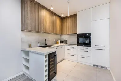 a kitchen with white cabinets and a counter top at Riva Cracovia in Kraków