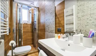 a white bed with two towels on top of it at Krowoderska Comfort Apartments - by Upstairs in Kraków