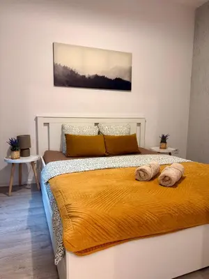 a bedroom with a bed with two pillows on it at Green Rest Apartment Cracow in Kraków
