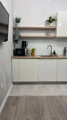 a kitchen with white cabinets and a sink at Green Rest Apartment Cracow in Kraków