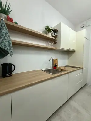 a kitchen with white cabinets and a sink at Green Rest Apartment Cracow in Kraków