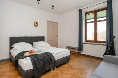 a bedroom with a bed with a tray of fruit on it at Wroblewskiego No 4 Residence in Kraków