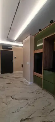 a large room with a large marble floor and a room with a wall at Apartament Wiślane Tarasy in Kraków