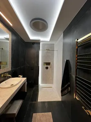 a bathroom with a sink and a shower and a toilet at Apartament Wiślane Tarasy in Kraków