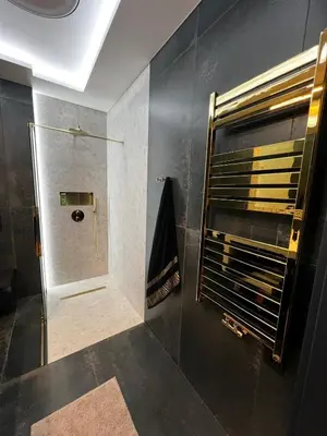 a bathroom with a shower with a glass door at Apartament Wiślane Tarasy in Kraków