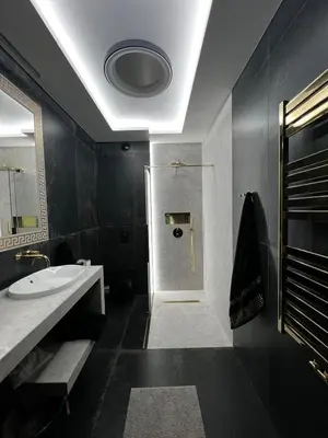 a black bathroom with a sink and a shower at Apartament Wiślane Tarasy in Kraków