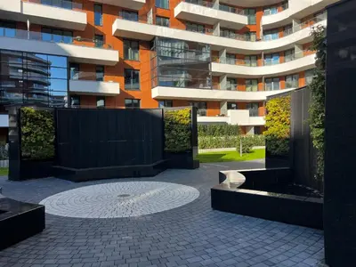 a building with a fountain in front of a building at Apartament Wiślane Tarasy in Kraków