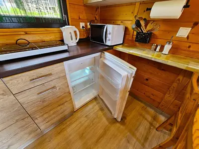 a kitchen with an open refrigerator and a microwave at Domki Mosorczyk in Zawoja