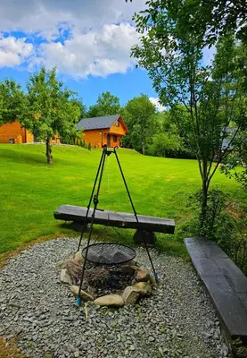 a swing in the middle of a park with a bench at Domki Mosorczyk in Zawoja