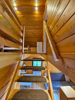 a room with five seats in a wooden building at Domki Mosorczyk in Zawoja